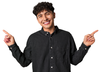 Young latin man pointing to different copy spaces, choosing one of them, showing with finger.