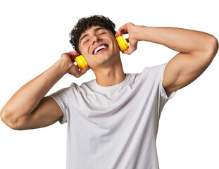 A young man enjoys his favorite tunes in high-quality sound, using wireless headphones for a...