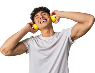A young man enjoys his favorite tunes in high-quality sound, using wireless headphones for a relaxing and entertaining audio experience.
