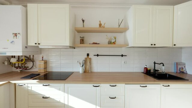 Slow establishing shot of a small kitchen area within an apartment