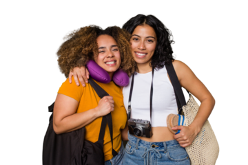 Two diverse friends on a beach vacation with vintage camera, beach bag, and travel pillow happy, smiling and cheerful.