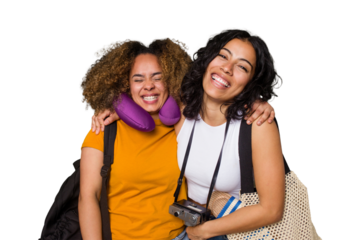 Two diverse friends on a beach vacation with vintage camera, beach bag, and travel pillow laughing and having fun.