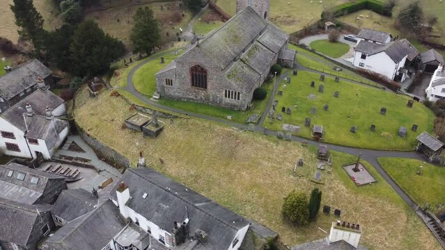 Cinematic aerial drone footage of Hawkshead Village and St Michael and All Angels Church.Cumbria UK.