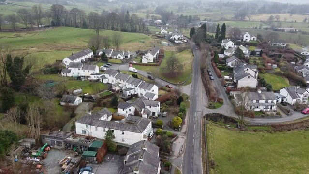 Cinematic aerial drone footage of Hawkshead Village and St Michael and All Angels Church.Cumbria UK.