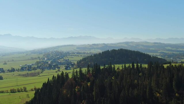Vast pastures by Zakopianka highway and majestic Tatra mountains Poland, aerial