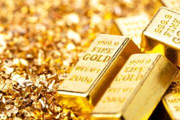 Gold bars on nugget grains background, close-up - 580618088