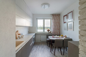 Stylish dining room interior design with dining table. Creative walls, white and wooden pannels.