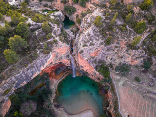 cueva turche a fascinating waterfall with a lagoon-like small lake from above from a bird's eye view