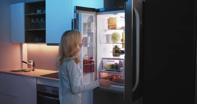 Women Looking For Food Inside Fridge