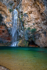 Fototapeta na wymiar beautiful waterfall with lake in a rock amphitheater the cueva turche in spain