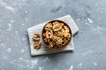 Fresh healthy walnuts in bowl on colored table background. Top view Healthy eating bertholletia concept. Super foods