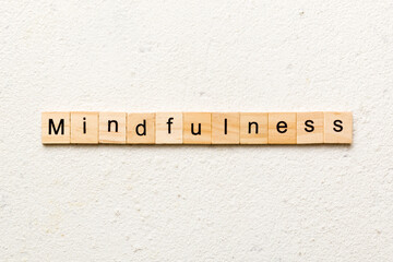 mindfulness word written on wood block. mindfulness text on table, concept