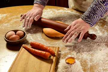 Grandma's hands kneading, dough for green noodles.