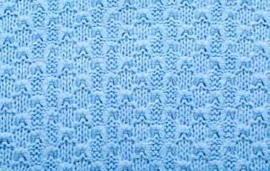 Background of knitted fabric with a pattern. Weaving winter clothes close-up.