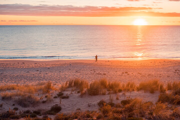 Fisherman's silhouette on Christies Beach at sunset, South Australia