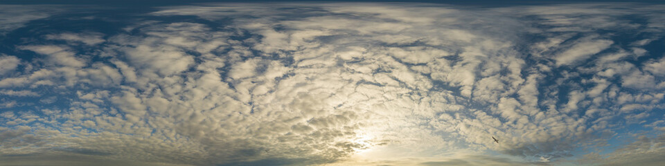 Panorama of a dark blue sunset sky with golden Cumulus clouds. Seamless hdr 360 panorama in spherical equiangular format. Full zenith for 3D visualization, sky replacement for aerial drone panoramas.