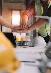 Team architects workers  join hands to join forces to join forces to work for the industry for success. Teamwork and professional colleagues : Workers' hands, teamwork concept.