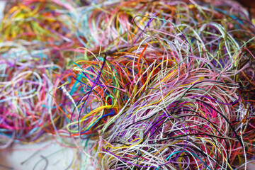 . Needlecraft silk thread ropes. Colored natural thread pile for sewing cloth scattered randomly like spaghetti.