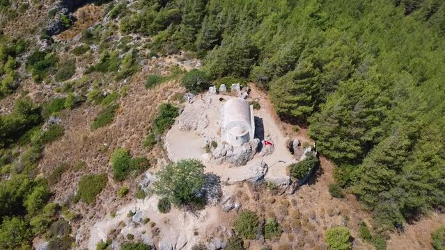 Tourists photographing the chapel in the abandoned historical Kayakoy in Fethiye. shooting with drone