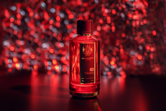 bottle of perfume on red background