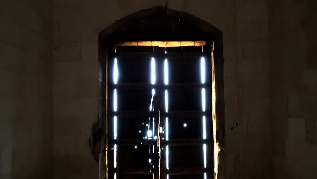 We see the main door of Zinciriye Madrasa and the light beams entering from the outside and the camera tilts down to scan the door. A fascinating image is formed.