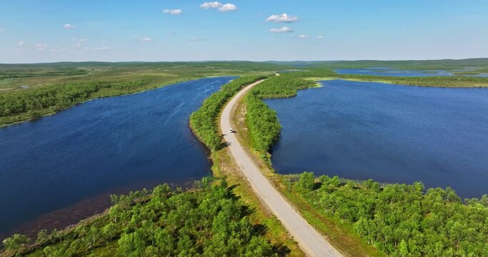 Aerial view following a car driving in polar nature, summer day in Kaldoaivi wilderness area, Finland
