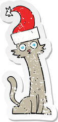 retro distressed sticker of a cartoon cat in christmas hat