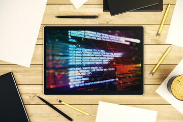 Modern digital tablet monitor with abstract programming language, research and development concept. Top view. 3D Rendering