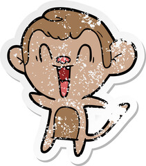 distressed sticker of a cartoon laughing monkey