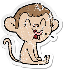 distressed sticker of a crazy cartoon monkey sitting