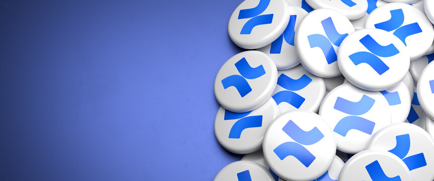 Icons of Confluence the corporate wiki software by Atlassian on a heap on a table. Copy space. Web banner format.