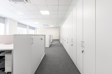 Carpeted corridor between lockers. Shrinking perspective. Selective focus.