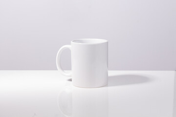 Obraz na płótnie Canvas White mug on white background for mockup