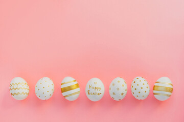 Easter background. Easter golden handmade decorated eggs on pink background. Minimal easter concept. Flat Lay of Golden Easter Eggs