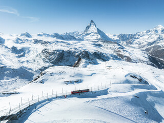 Fototapeta na wymiar Zermatt, Switzerland -The train of Gonergratbahn running to the Gornergrat station and observatory in the famous touristic place with clear view to Matterhorn.