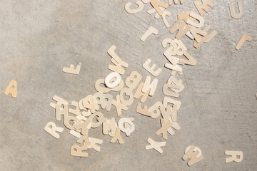 Wood alphabet letters thrown on concrete cement texture floor background