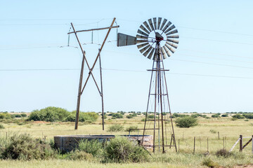 Windmill with dam and  electricity pylon between Douglas and Prieska