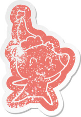 female bear cartoon distressed sticker of a wearing santa hat