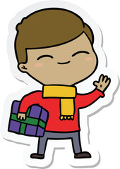 sticker of a cartoon smiling boy with gift