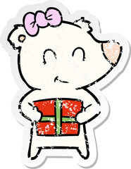 distressed sticker of a female polar bear with christmas present