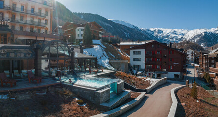 Outdoors infinity pool with an amazing view on the Zermatt Matterhorn peak. Luxury hotel concept....