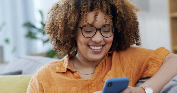 Happy woman laughing on a phone and sofa for funny internet meme, social media post or texting on mobile app. Young black person on couch or living room typing on a cellphone, smartphone or web chat