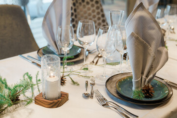 decorated christmas table with gifts and candles in the room. Restaurant christmas decoration.