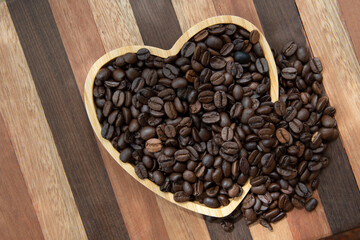 coffee beans in heart-shaped tra,y representing love of coffee