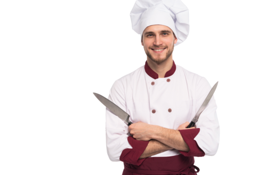 Portrait of a handsome positive male chef cook holding knifes isolated 