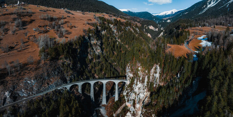 Aerial view famous mountain in Filisur, Switzerland. Landwasser Viaduct - world heritage with train Glacier express in Swiss Alps.