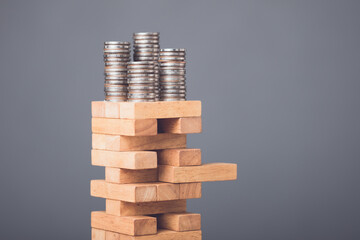 Risks in business or financial concept. Idea to prevent risk in business. Business man playing and selective right or risky piece of tower wooden block game and prevent falling down. - obrazy, fototapety, plakaty