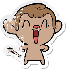 distressed sticker of a cartoon laughing monkey