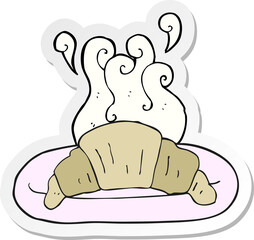 sticker of a cartoon croissant