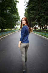 Young teenage girl casting glance while walking on the road.